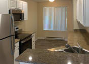 Thumbnail 18 of 31 - Kitchen with a Sink and Refrigerator at Arcadia Townhomes, Federal Way, WA, 98023