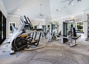 Thumbnail 64 of 65 - A spacious home gym with a variety of equipment.
