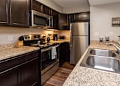 Thumbnail 11 of 37 - kitchen with moden appliances and sleek countertops