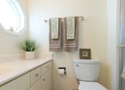 Thumbnail 14 of 37 - A white toilet sits next to a sink in a bathroom.