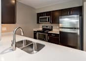 Thumbnail 6 of 37 - stainless steel sink, oven, and fridge in spacious kitchen