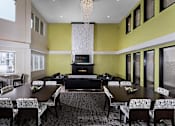 Thumbnail 18 of 27 - a clubroom with lots of different seating options, large tv, and chandelier