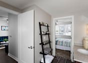 Thumbnail 15 of 27 - the corner of a bathroom fashioned with a standing bookshelf that is storing bathroom items