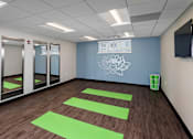 Thumbnail 25 of 27 - a yoga studio with large mirrors and yoga mats