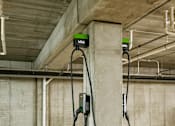 Thumbnail 16 of 22 - Two electric vehicle charging stations are installed in a parking garage.