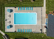 Thumbnail 6 of 24 - An aerial view of a swimming pool with lounge chairs and umbrellas.