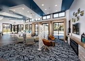 Thumbnail 20 of 37 - interior community room with comfortable seating and large windows overlooking pool