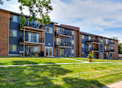 Thumbnail 13 of 13 - apartment building in the summer with balconies and windows