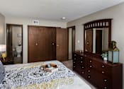 Thumbnail 4 of 13 - bedroom with dresser, large closet, and attached bathroom