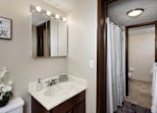 Thumbnail 7 of 13 - bathroom with mirror vanity, sink, and shower stall