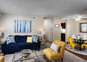 Thumbnail 8 of 13 - living room with artwork, couch, coffee table right next to dining table and kitchen