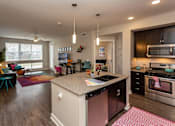 Thumbnail 4 of 27 - a view of a kitchen and living room in a home