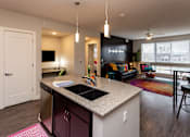 Thumbnail 5 of 27 - an open kitchen and living room with a large window and a sink