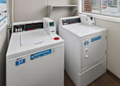 Thumbnail 21 of 24 - A laundry room with a washer and dryer.