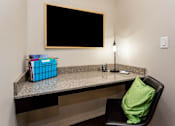 Thumbnail 13 of 27 - a pocket office just off of the kitchen area fashioned with a chair, pillow, lamp, and blackboard