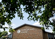 Thumbnail 10 of 24 - A building with a sign that says Country Club Village.