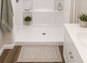 Thumbnail 3 of 17 - A white bathroom with a shower curtain and a towel hanging on the door.