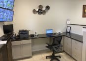 Thumbnail 7 of 18 - a desk with a computer and a printer on it at Colonial Apartments, Florida, 32808