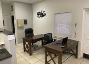 Thumbnail 12 of 18 - an office with two desks and two chairs at Colonial Apartments, Orlando