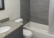 Thumbnail 6 of 18 - a bathroom with a sink toilet and bathtub at Colonial Apartments, Florida