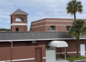 Thumbnail 5 of 18 - a picture of a building with a clock tower in the background at Colonial Apartments, Orlando