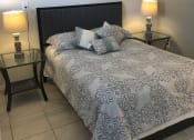 Thumbnail 11 of 18 - a bedroom with a bed and two night stands at Colonial Apartments, Orlando Florida