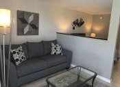 Thumbnail 15 of 18 - a living room with a couch and a coffee table at Colonial Apartments, Orlando, FL 32808