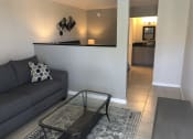 Thumbnail 14 of 18 - a living room with a couch and a coffee table at Colonial Apartments, Florida, 32808