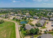 Thumbnail 4 of 30 - an aerial view of a neighborhood with houses and a pond at Chapel Ridge of Stillwater, Stillwater, 74075
