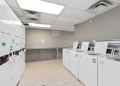 Thumbnail 18 of 39 - a break room with a bunch of machines and appliances in it at Emerald Greens, Norman Oklahoma