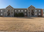 Thumbnail 9 of 39 - an exterior view of an apartment building with a large yard at Emerald Greens, Norman, OK 