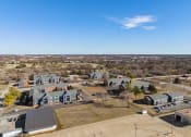 Thumbnail 15 of 39 - a aerial view of a neighborhood with houses and a city in the background at Emerald Greens, Norman, OK 73072