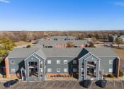 Thumbnail 11 of 39 - a view of a building from above with cars parked in a parking lot at Emerald Greens, Norman Oklahoma