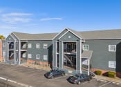 Thumbnail 2 of 39 - an apartment building with cars parked in front of it at Emerald Greens, Norman, OK