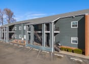 Thumbnail 10 of 39 - an exterior view of a gray building with a porch and stairs at Emerald Greens, Norman, 73072