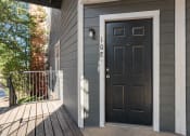Thumbnail 14 of 39 - the front door of a gray house with a black door at Emerald Greens, Oklahoma, 73072