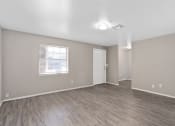 Thumbnail 33 of 39 - an empty living room with a white door and a window at Emerald Greens, Norman