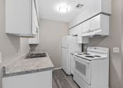 Thumbnail 36 of 39 - a kitchen with white appliances and white cabinets and a sink at Emerald Greens, Norman, OK 73072