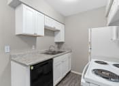 Thumbnail 38 of 39 - a kitchen with white cabinets and appliances and a white stove and refrigerator at Emerald Greens, Norman, 73072