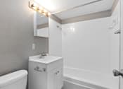 Thumbnail 32 of 39 - a bathroom with a sink and a tub and a mirror at Emerald Greens, Norman Oklahoma