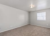 Thumbnail 23 of 39 - an empty room with carpet and a window at Emerald Greens, Norman, OK