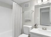 Thumbnail 16 of 17 - a white bathroom with a shower and a toilet and a sink at Lakeside Villas, Orlando, FL