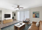 Thumbnail 11 of 17 - a living room with a couch and a ceiling fan at Lakeside Villas, Orlando, FL 32817