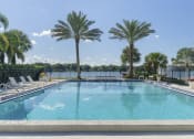 Thumbnail 8 of 17 - a large pool with palm trees and chairs around it at Lakeside Villas, Florida, 32817
