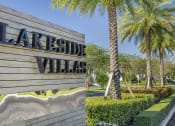 Thumbnail 1 of 17 - a sign for the lakeside villas at lakeside village with palm trees at Lakeside Villas, Florida