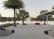 Thumbnail 9 of 17 - a dock with palm trees and a fountain  and a lake at Lakeside Villas, Orlando Florida