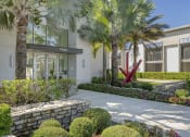 Thumbnail 2 of 17 - a building with palm trees and a sidewalk in front of it at Lakeside Villas, Orlando, FL