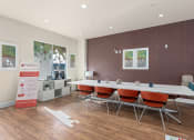 Thumbnail 25 of 51 - a conference room with a long table and chairs at Lake Lofts at Deerwood, Jacksonville, FL, 32216