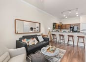 Thumbnail 45 of 51 - a living room with a couch and a coffee table in front of a kitchen at Lake Lofts at Deerwood, Florida, 32216
