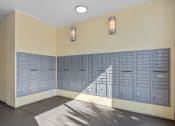 Thumbnail 40 of 51 - an empty locker room with blue lockers on the wall and a staircase at Lake Lofts at Deerwood, Jacksonville, FL, 32216